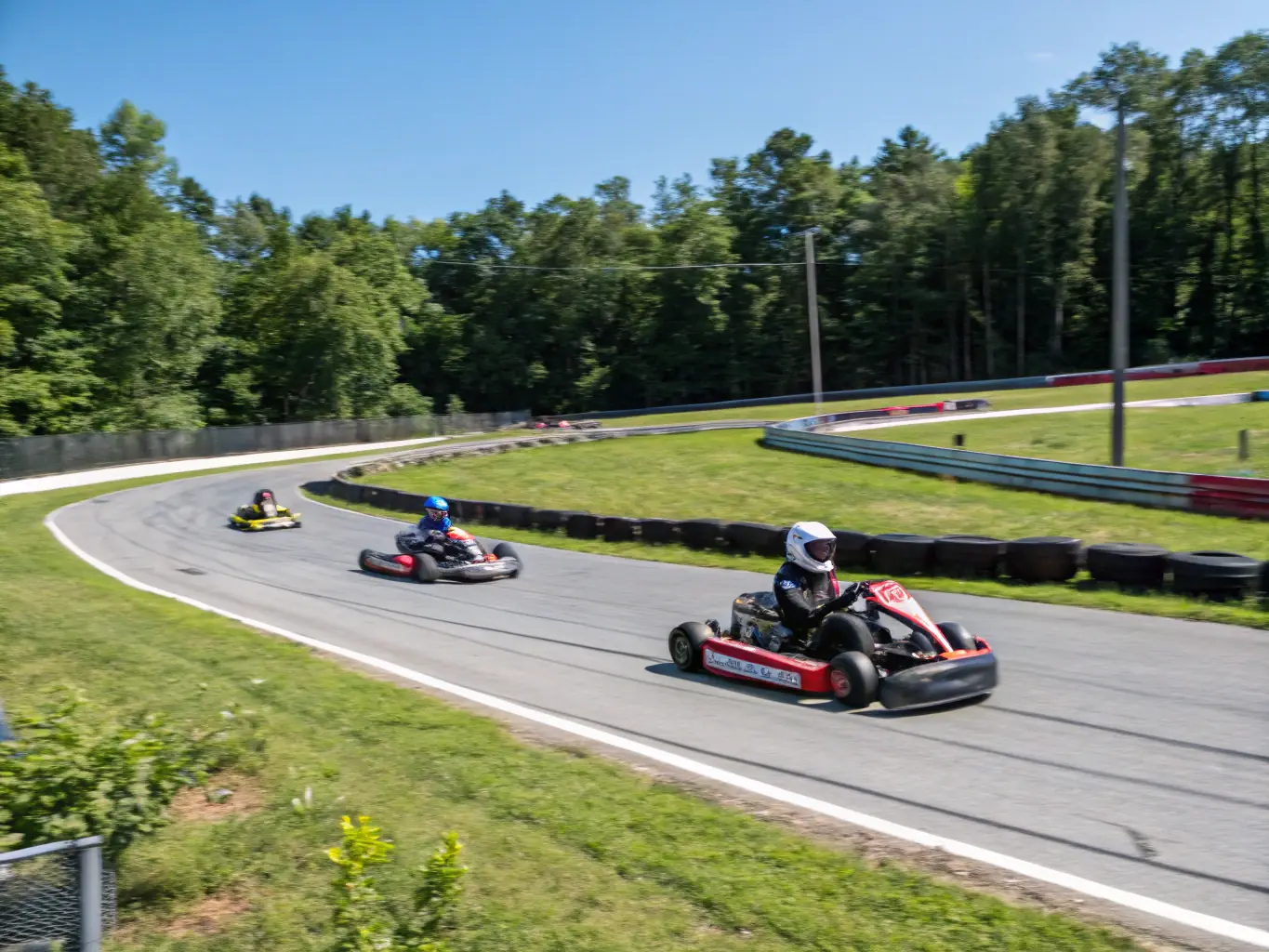 A high-speed go-kart race with young participants, showcasing the excitement and skill involved in early motorsport training.